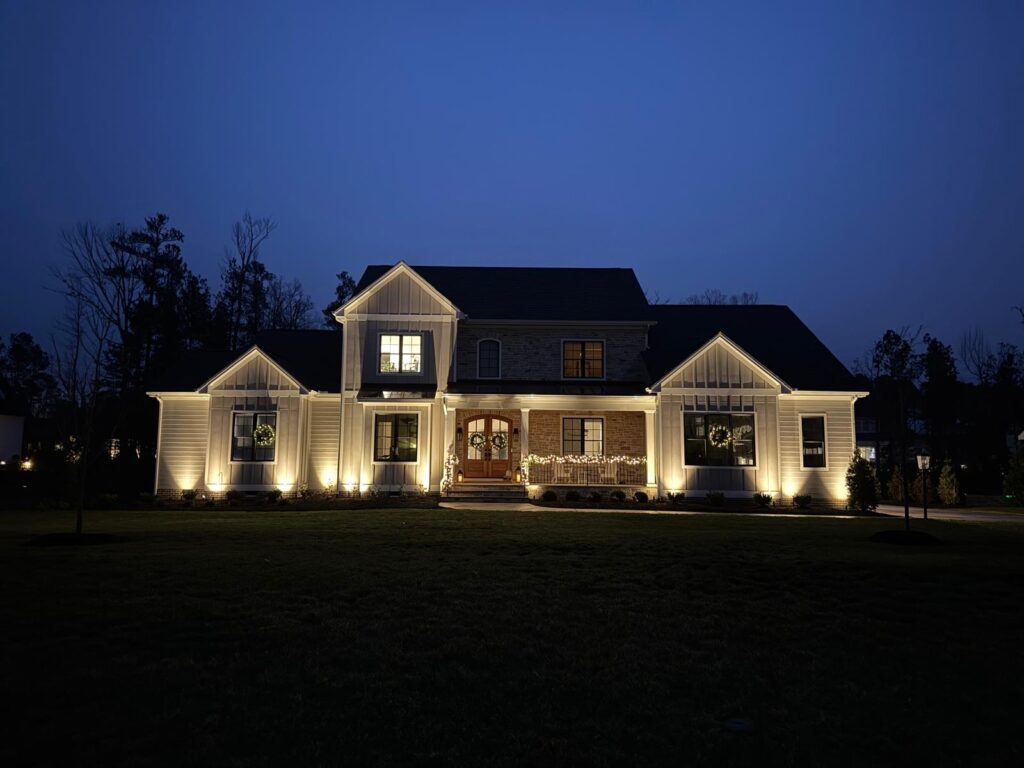 Home with landscape lighting soon after dark