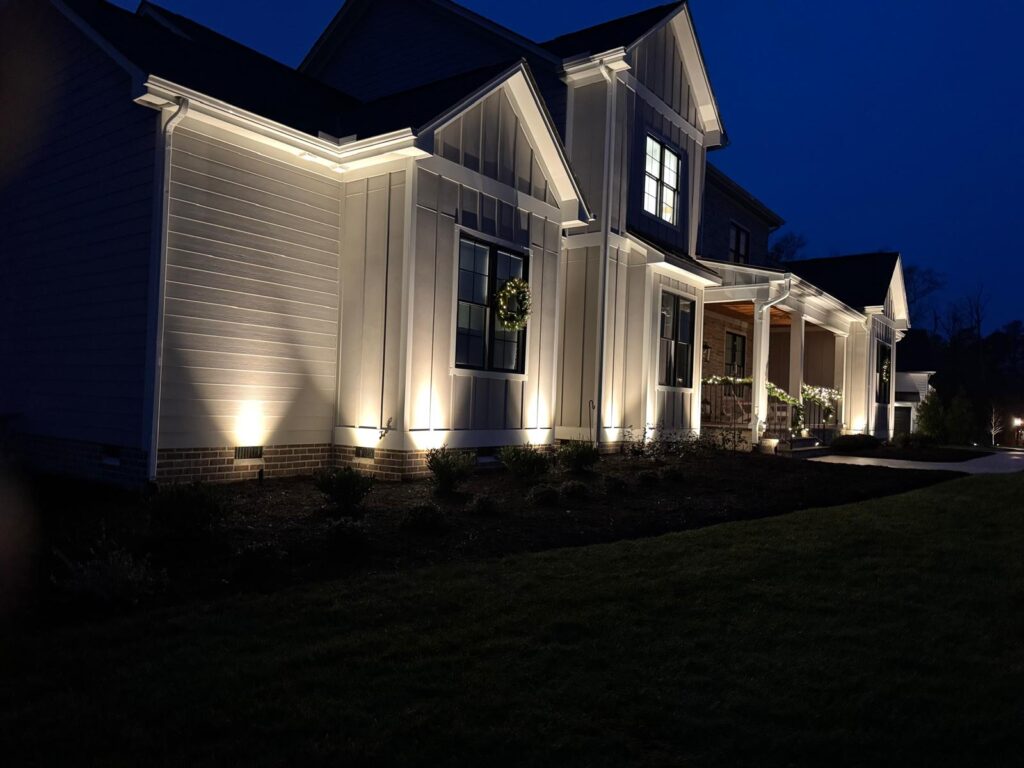 Angled landscape lighting at night in Midlothian