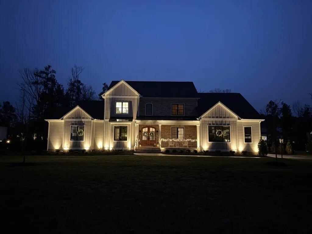 Home with landscape lighting soon after dark