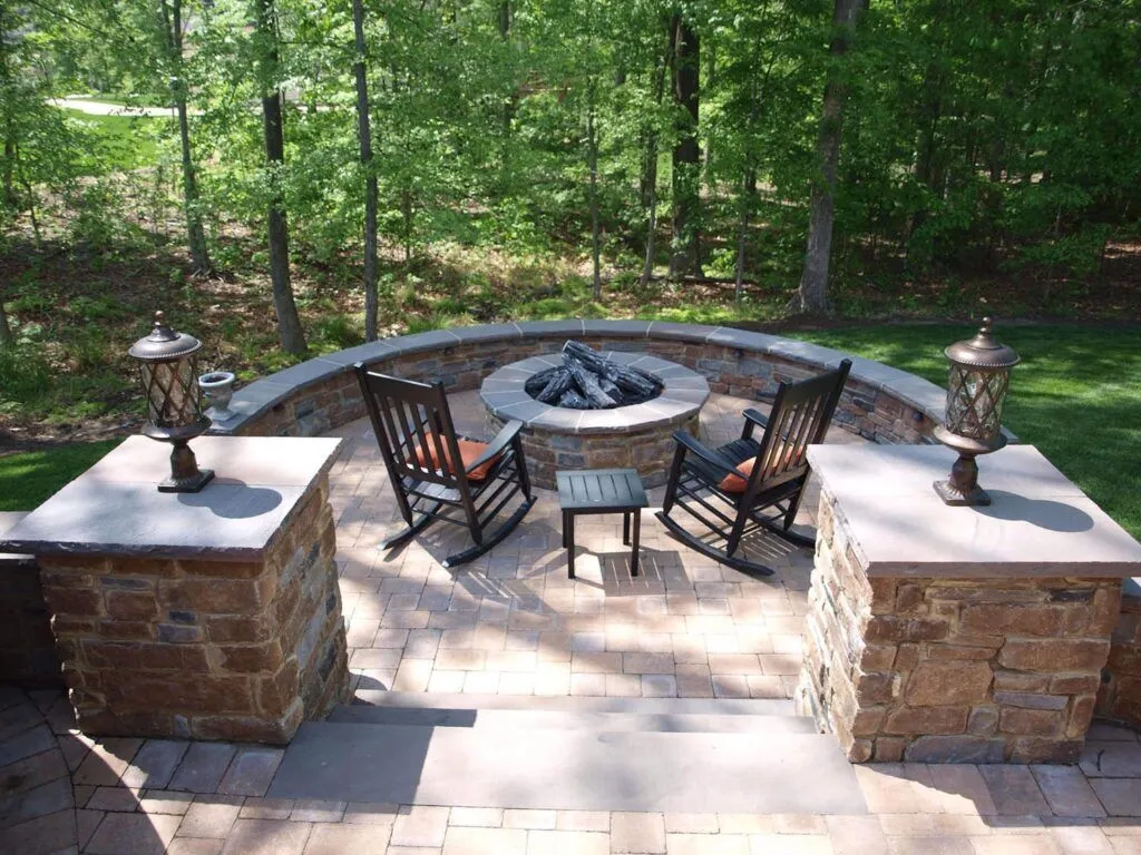 Fire pit in a wooded area installed by GSU's hardscaping services